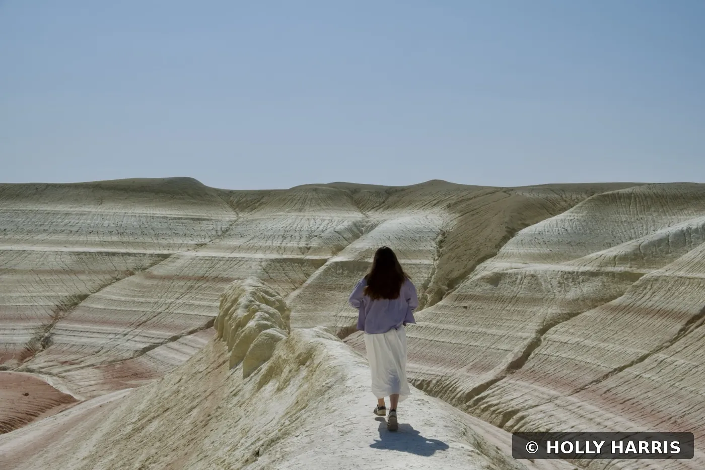 Holly Harris walking through the landscape in Mangystau, Kazakhstan
